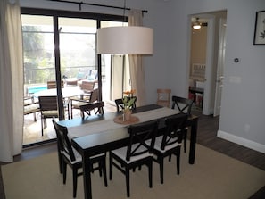 Open dining area with extra large sliding doors and pool view