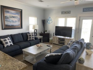 Beautiful and well lit living area with Smart TV big screen and pull out sofa.
