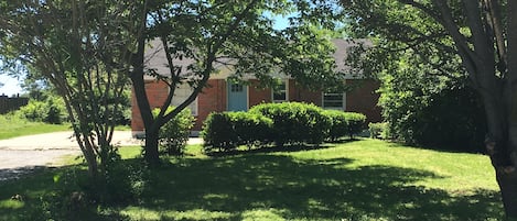 Home is set back off street with peaceful front yard garden.