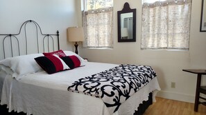 Bedroom with lots of windows with great views, and queen size bed.