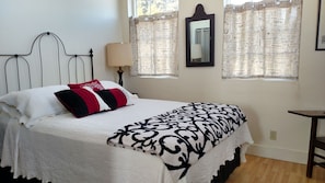 Bedroom with lots of windows with great views, and queen size bed.