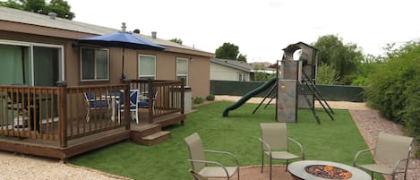 AMAZING Fenced backyard with playset, Firepit, BBQ, and sitting area