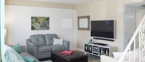 Living room with pull out couch (Queen Bed) and ottoman (twin bed).