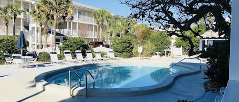 View of the heated pool and lounge chairs from the porch.