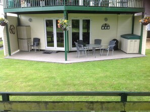 Guest outside seating area with views over the garden and golf course.