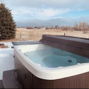 You’ll love the 6 person spa in our private backyard backed by protected land.