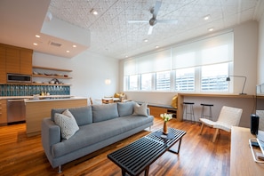 General living area with windows looking down three stories on back alley