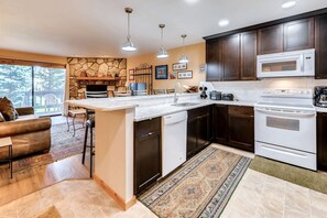 Kitchen is fully equipped with full size stove, refrigerator, and dishwasher. Small appliances include standard coffee maker, blender, crockpot, toaster.