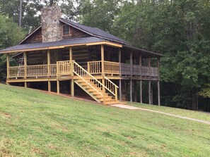 Front porch wraps around three sides of the cabin, perfect for viewing wildlife.