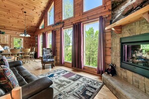 Living Room with fireplace & high ceilings
