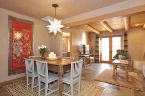 Looking from dining area to master bedroom, living room, and patio doors.