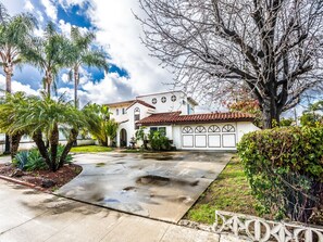 Spanish style, circular drive way easy in/out, 2 car garage & corner lot.