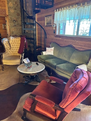 Antique seating area is comfortable for chats or watching television. 