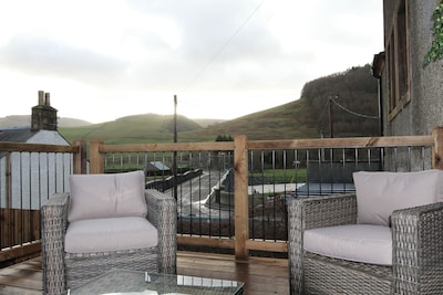 Relax in this luxury renovated flat with a hot tub and log burner