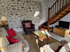 Living room with stairs to bedrooms. UK TV channels 