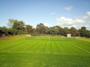 Anyone for tennis? Our own grass tennis court for players of all abilities
