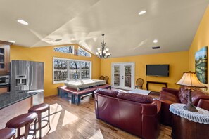 The vaulted ceiling in the family room lets in lots of light from the lake side.