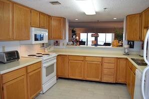 Huge kitchen area, has a washer and dryer are in a small room off kitchen.