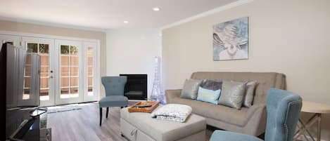 Living Space with Smart TV and comfortable Sofa and warm fireplace.