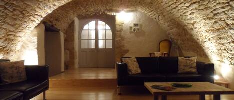 Unique vaulted lounge at night, which has views of the dordogne valley.