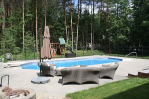 Backyard patio set with large umbrella and firepit