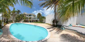 Backyard Pool with lounge and a garden. A few steps away from the beach.