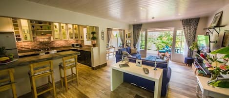 Open plan living space with french doors opening to the tranquil private patio.
