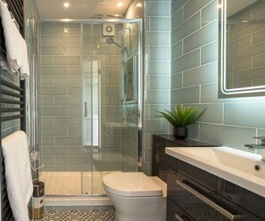 New, modern bathroom with heated floor, heated towel rail and mirror. 