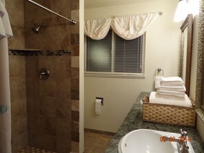 Main bath, with double sinks and shower heads on both sides of the shower wall