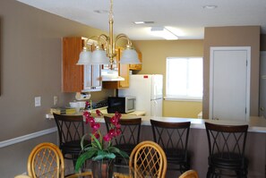 Kitchen area with seating for four at bar!