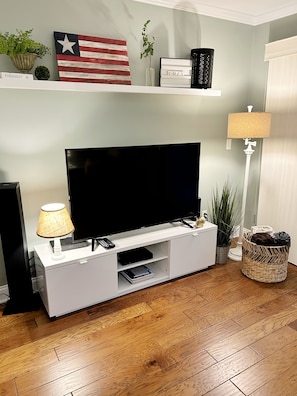55 inch smart TV,  DVD player and DVD library 