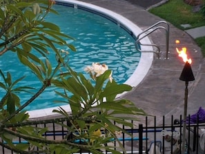 Tiki torches and plumeria flowers abound in your lush tropical pool view from your own lanai 