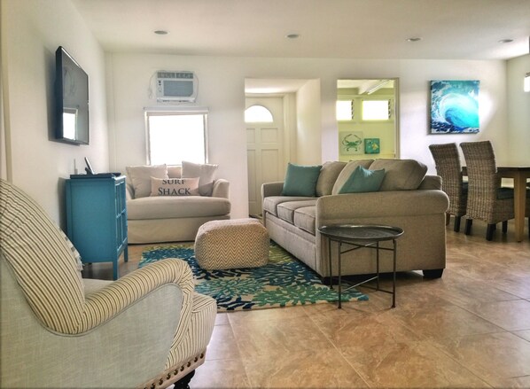Living area and dining, with peak of office in the back.
