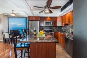 Updated kitchen with Asian mahogany cabinets and Kitchen Island. 
