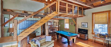 Bright, spacious game room with pool and foosball tables for hanging out.