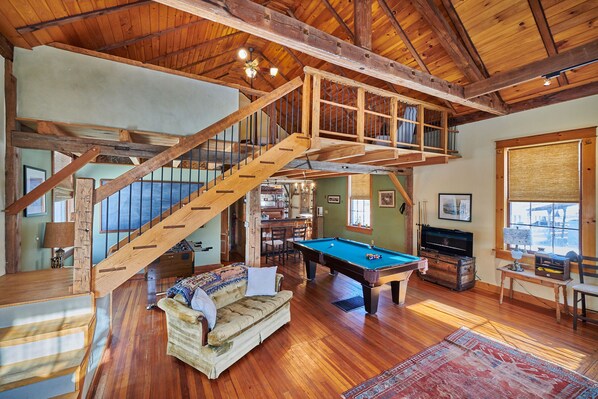 Bright, spacious game room with pool and foosball tables for hanging out.