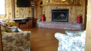 Living room so cozy and comfortable. Bay window. HBO.  Fireplace and brick heart