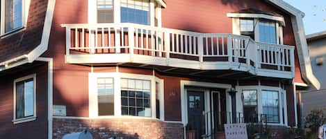 Front exterior of Ocean's Breeze.  Four large bay windows facing west to the sea