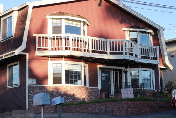 Front exterior of Ocean's Breeze.  Four large bay windows facing west to the sea