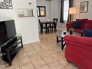 Living room with Roku TV and dining area.