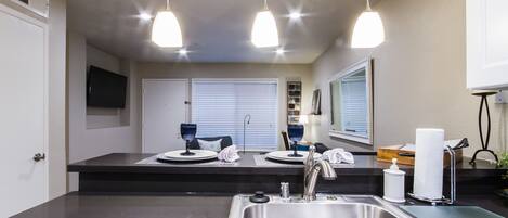 View of TV from Kitchen.  Dimmable pendant lights over bar.