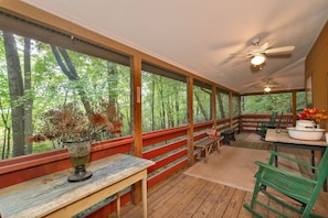 Covered screened porch with rockers to enjoy the cool mountain air. 