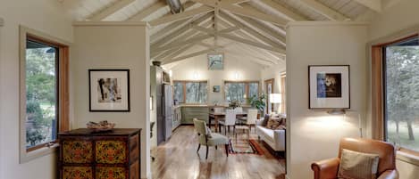 View of living room and kitchen from bedroom. 