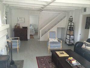 Living area looking toward front bedroom and stairs to loft bedroom