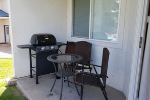 Patio with grill and seating—perfect for relaxing cookouts and casual outdoor dining.