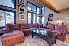 HUGE leather sectional in great room with original artwork and ski Mt. views!!