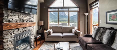 Relax and enjoy stunning mountain views in front of the fireplace in your home away from home.