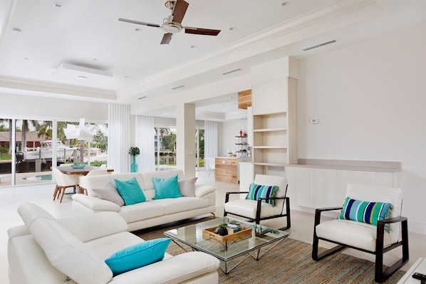 Living room area is open, light with a view of the pool and cana