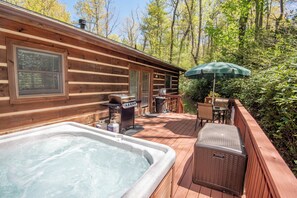 Hot tub, gas grill (propane provided), and table for eating on the back porch