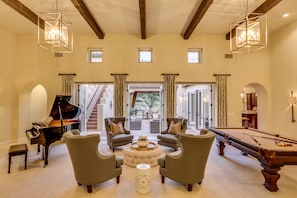 Game room with billiards, grand piano and seating